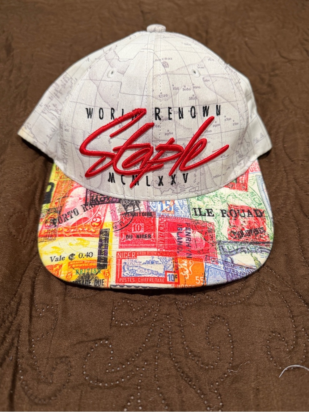 Staple Pigeon White Cap with Red Embroidered Script and Multicolor Printed Brim